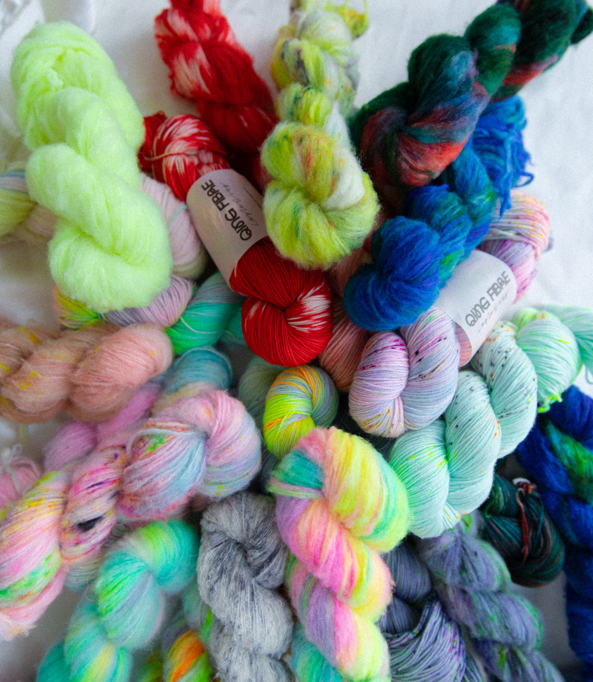 Colorful yarn skeins in various shades on a white background