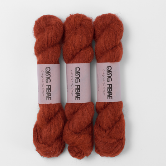 Three labelled hanks of All Hallows Melted Baby Suri 25g yarn in rust red.