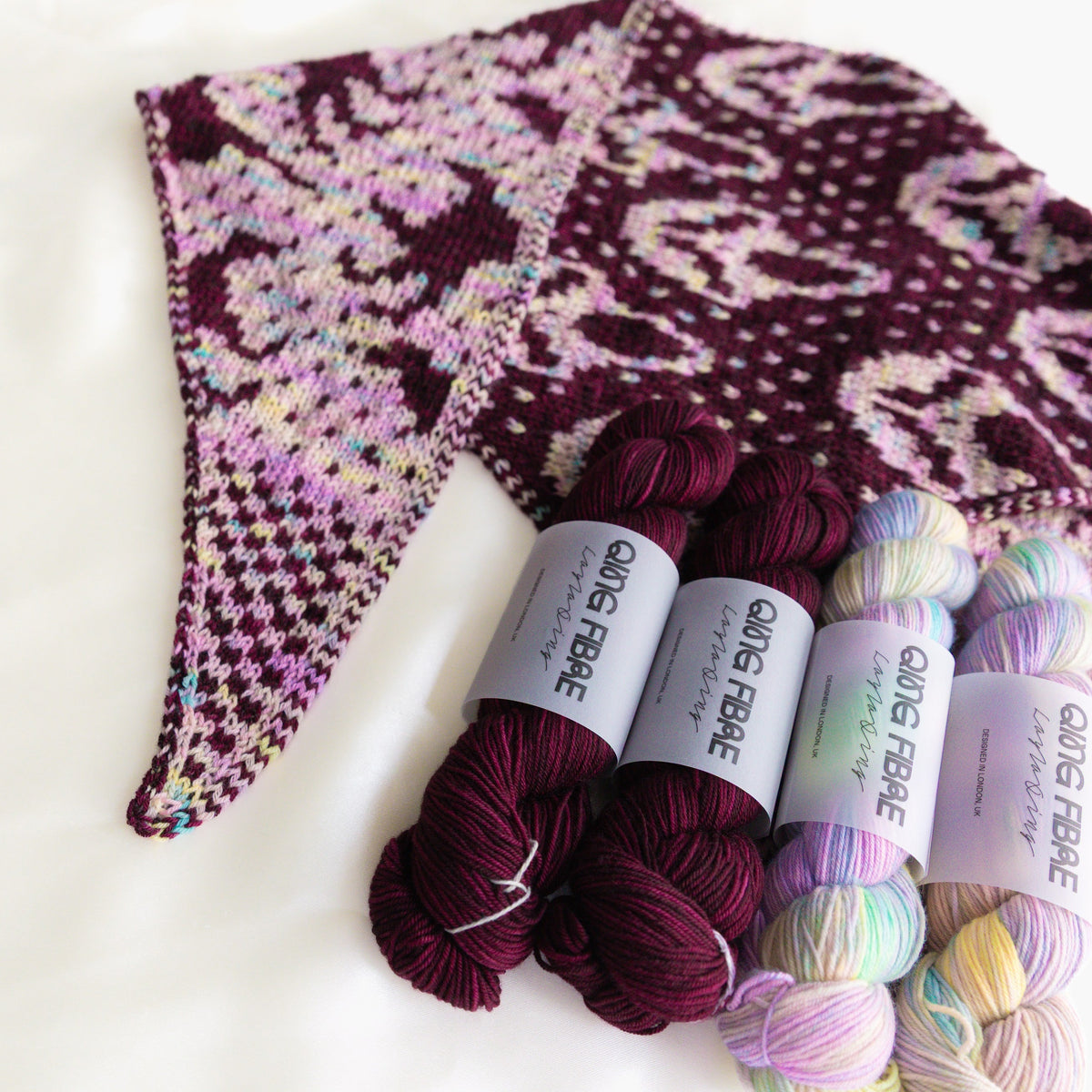 Slasher scarf and four yarn skeins in Mother of Pearl and Hush, shown close up