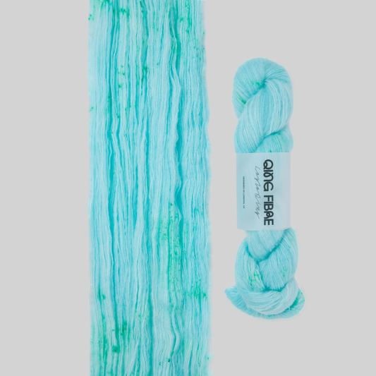Veranita Nassau yarn, with an open skein and twisted skein on a grey background