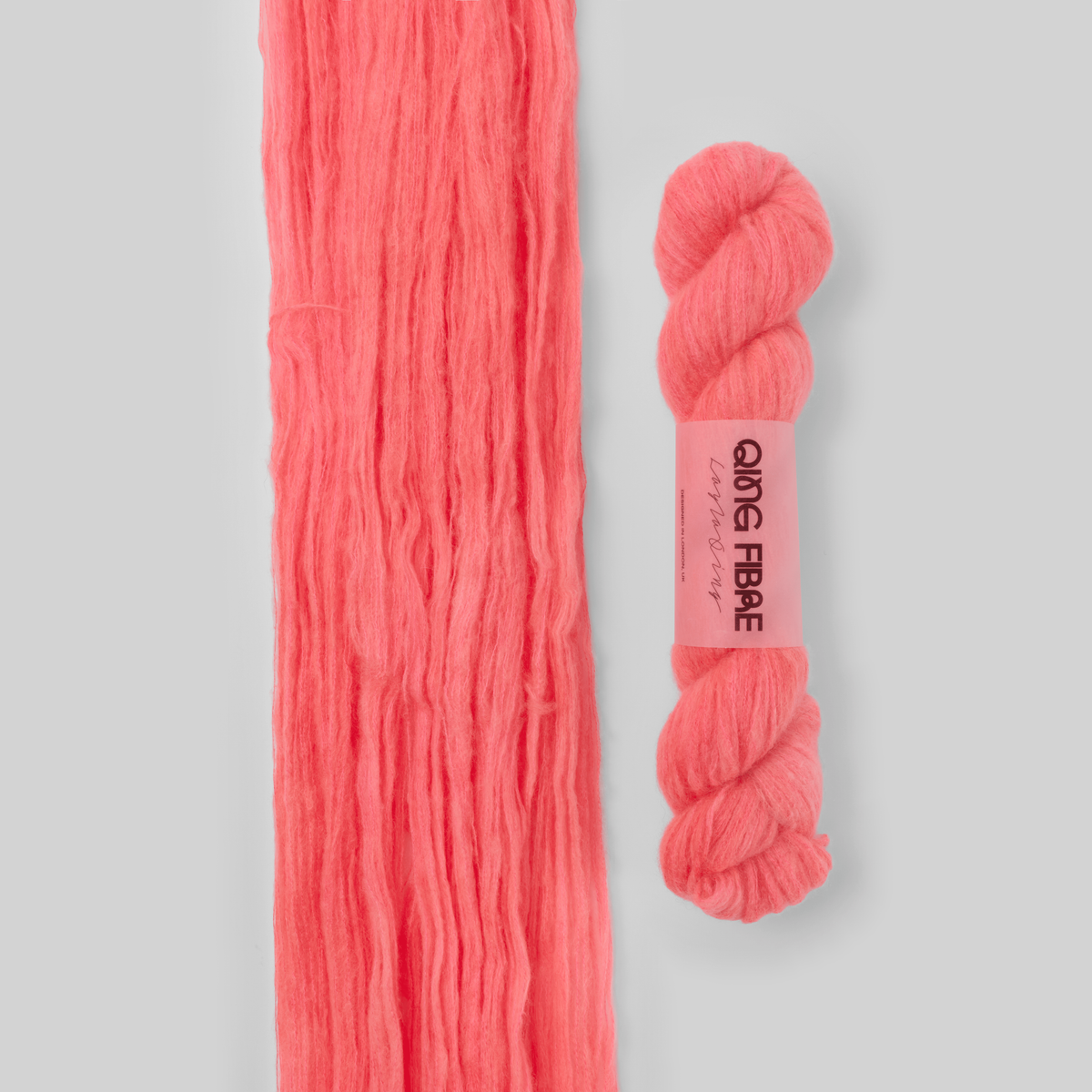 Veranita Shrimp yarn, with an open skein and twisted skein on a grey background