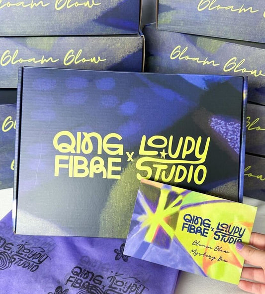 Qing Fibre x Loupy Studio Gloam Glow mystery box packaging with branded colorful box and card