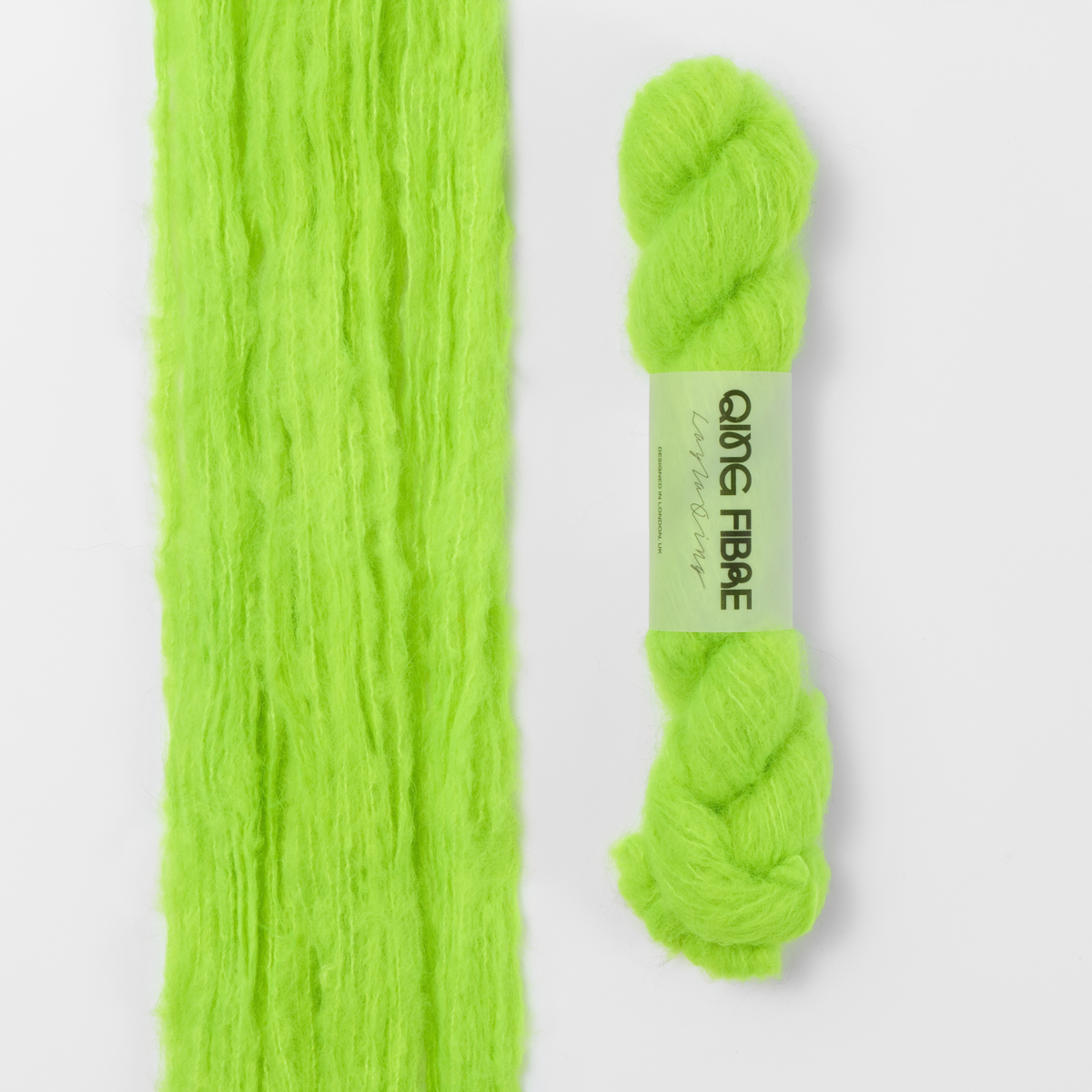 Ninja Turtle Melted Baby Suri 25g: neon green yarn, shown loose beside a labelled hank.