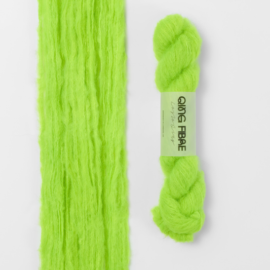 Ninja Turtle Melted Baby Suri 25g: neon green yarn, shown loose beside a labelled hank.