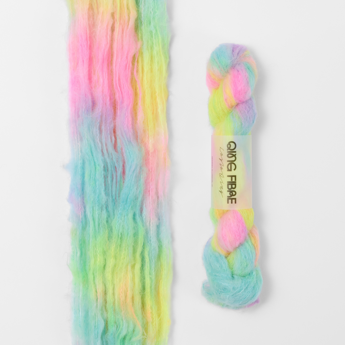 Flying Saucer Melted Baby Suri 25g: bright pink, yellow and turquoise green yarn, shown loose beside a labelled hank.