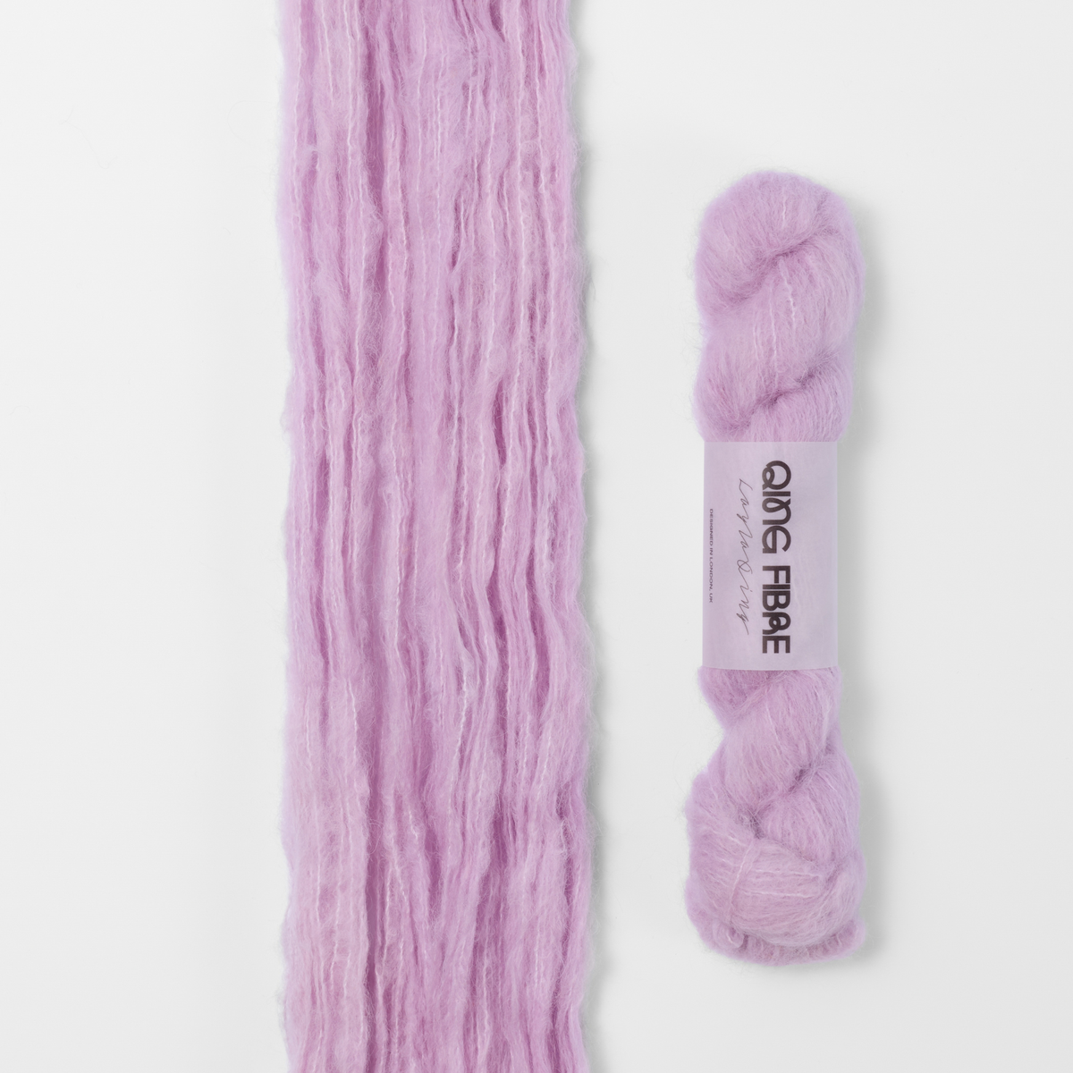 Thistle Melted Baby Suri 25g: pale lilac yarn, shown loose beside a labelled hank.