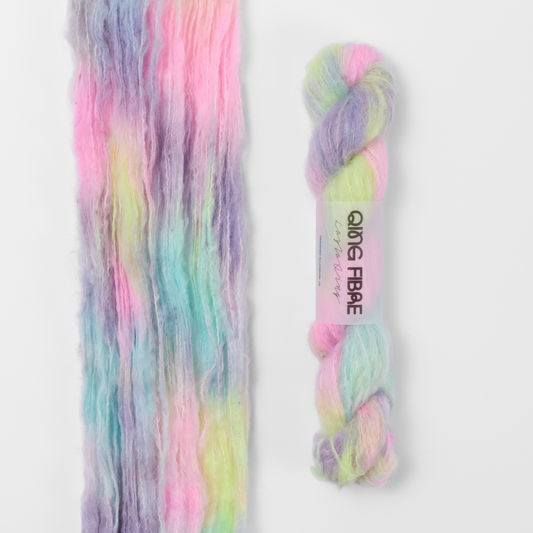 Cloud Melted Baby Suri 25g: pastel pink, yellow, blue and lilac yarn, shown loose beside a labelled hank.