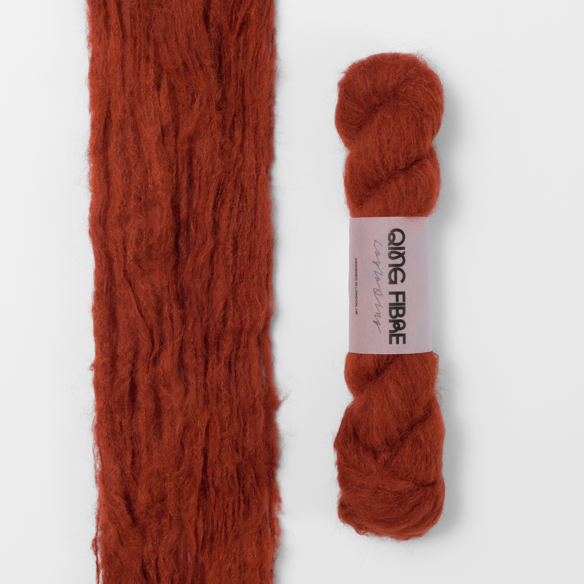 All Hallows Melted Baby Suri 25g: rust red yarn, shown loose beside a labelled hank.