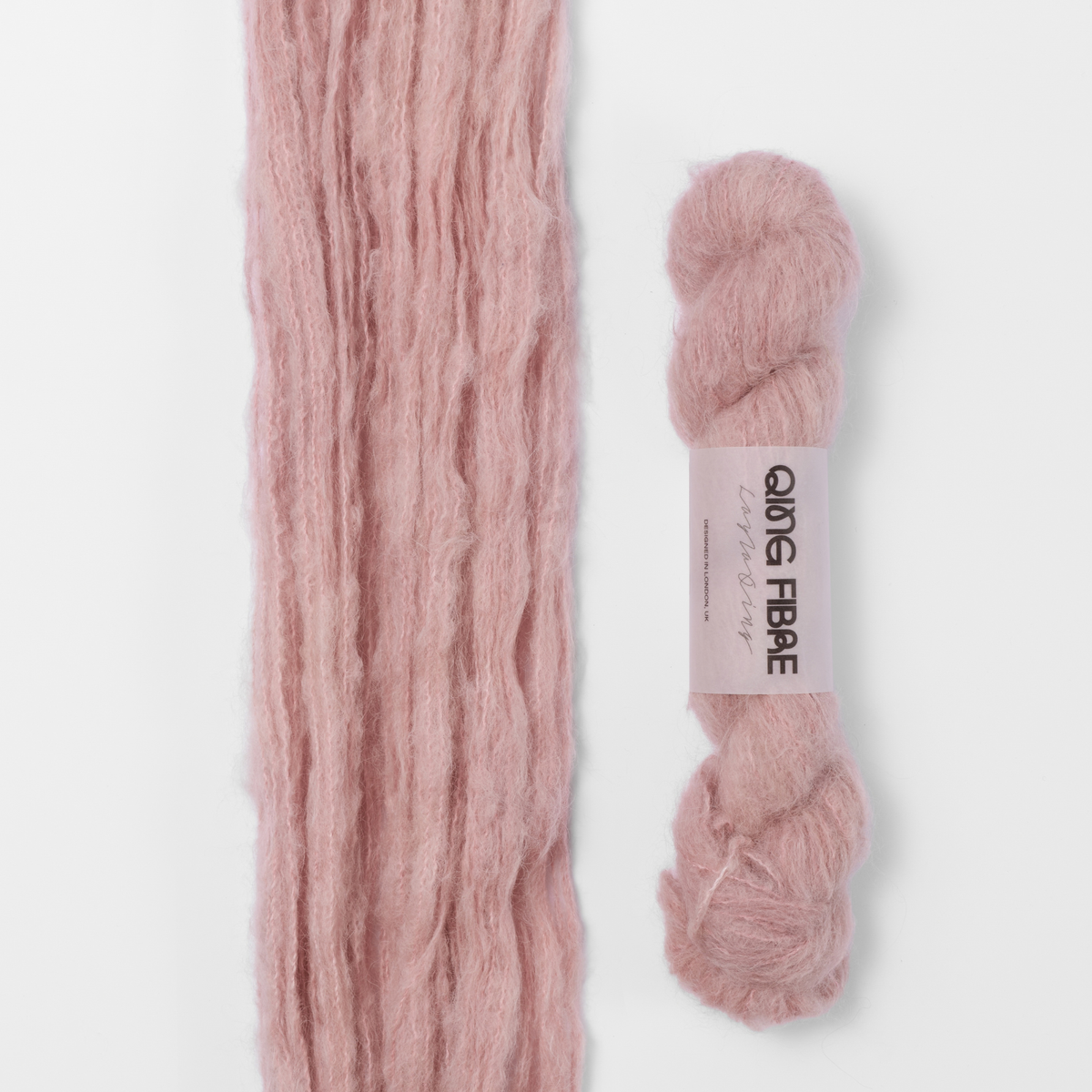 Soft Clay Melted Baby Suri 25g: dusty pink yarn, shown loose beside a labelled hank.