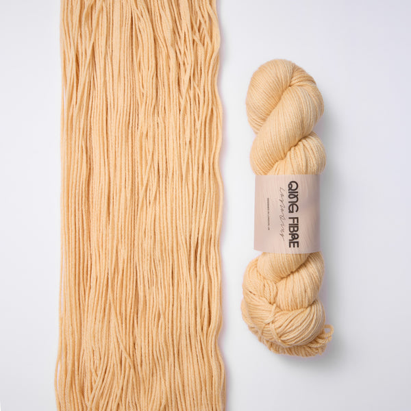 Qing Fibre Awoken colourway detail — hand-dyed yarn skein close-up in warm beige