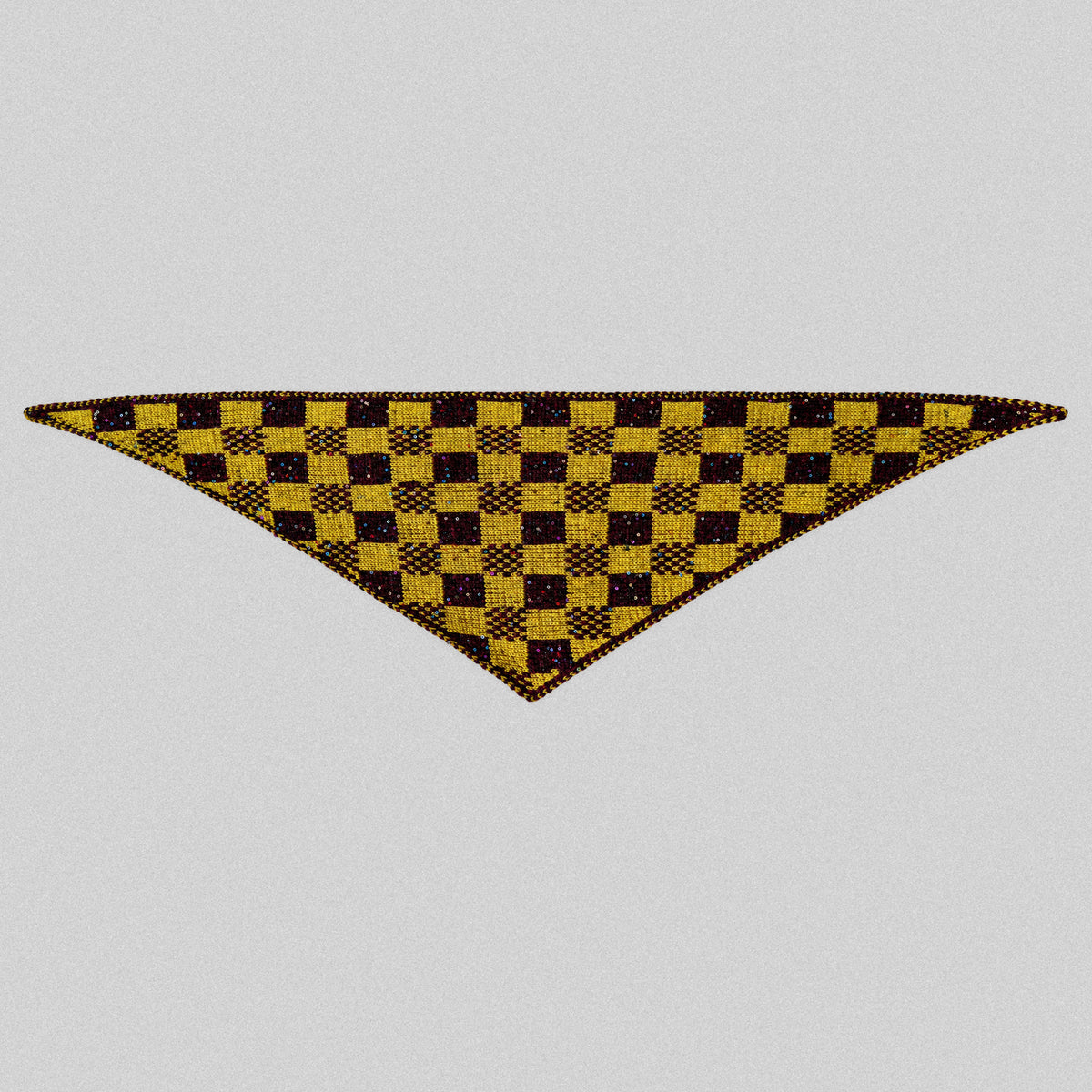 Harlequin Gambit triangle scarf laid flat, showing burgundy and yellow checks, sequins and pointed ends.