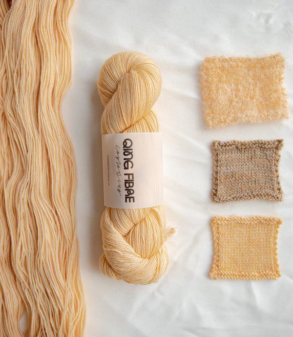 Qing Fibre Awoken colourway — hand-dyed yarn skein with knitted swatches in warm beige tones