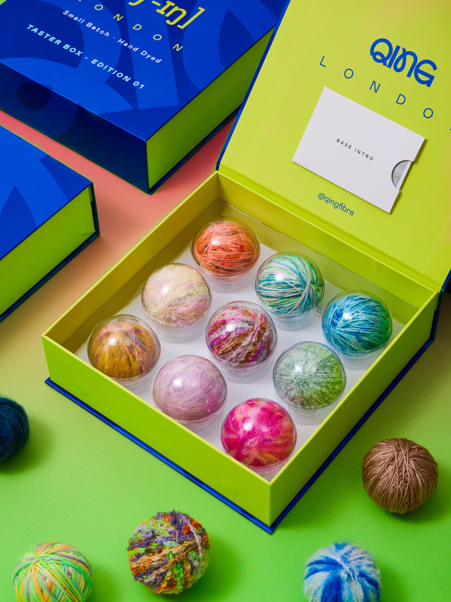 Qing Fibre Taster Box Edition 01 open with 9 hand-dyed yarn balls in spring colourways