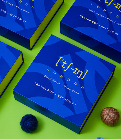 Qing Fibre Taster Box packaging — blue branded boxes with London small-batch hand-dyed yarn branding