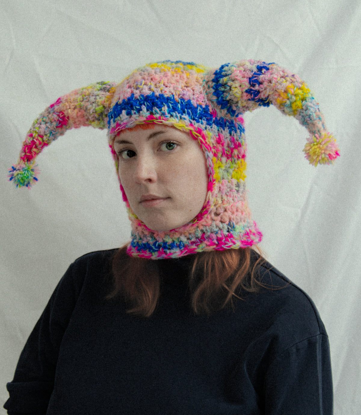 Colourful hand-knitted jester hat made with yarn from the Qing Fibre Taster Box