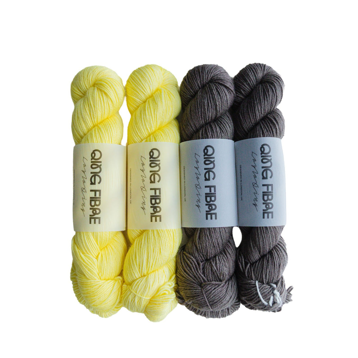 Two skeins each of Dashing Fingering 50g in Cocoon and Soot