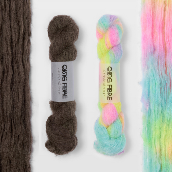 Soot and Flying Saucer Melted Baby Suri 25g yarn, with two twisted skeins between the open skeins on a grey background.
