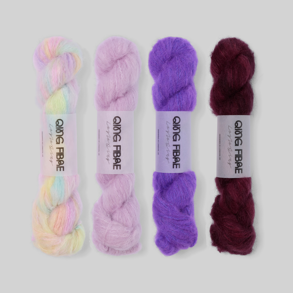 Lilac to Plum Suri 25g fade set: Mother of Pearl, Thistle, Prince and Hush twisted skeins arranged from pearly pastels through lilac and violet to deep plum.