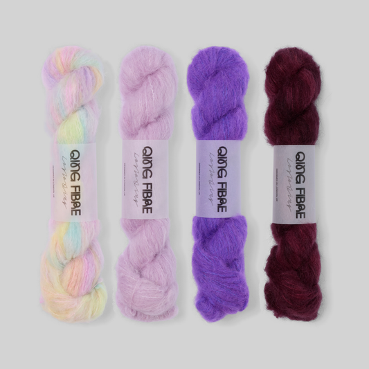 Lilac to Plum Suri 25g fade set: Mother of Pearl, Thistle, Prince and Hush twisted skeins arranged from pearly pastels through lilac and violet to deep plum.