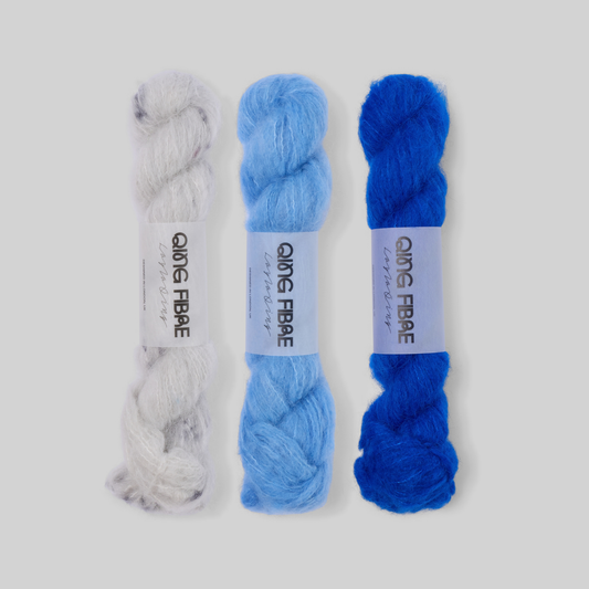 Silver to Cobalt Suri 25g fade set: Platinum, Drift and Hero twisted skeins arranged from silvery grey through light blue to cobalt.