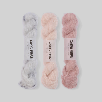 Soft Blush Suri 25g fade set: Platinum, Dust and Soft Clay twisted skeins arranged from silvery grey through pale blush to dusty rose.