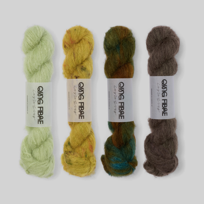 Woodland Suri 25g fade set: Cicada, Guardian, Nyx and Soot twisted skeins arranged from pale green through earthy gold and deep green to smoky brown.