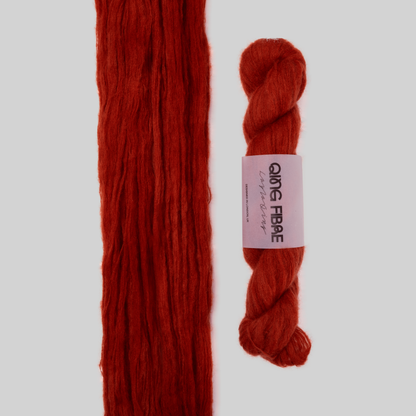 Veranita All Hallows yarn, with an open skein and twisted skein on a grey background
