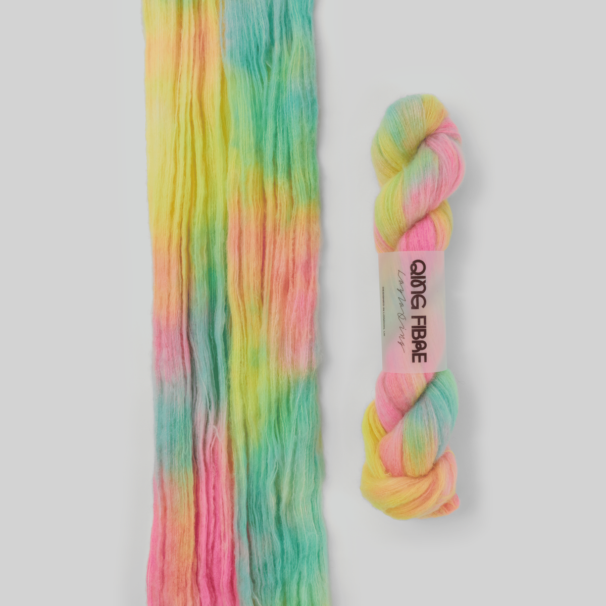 Veranita Flying Saucer yarn, with an open skein and twisted skein on a grey background