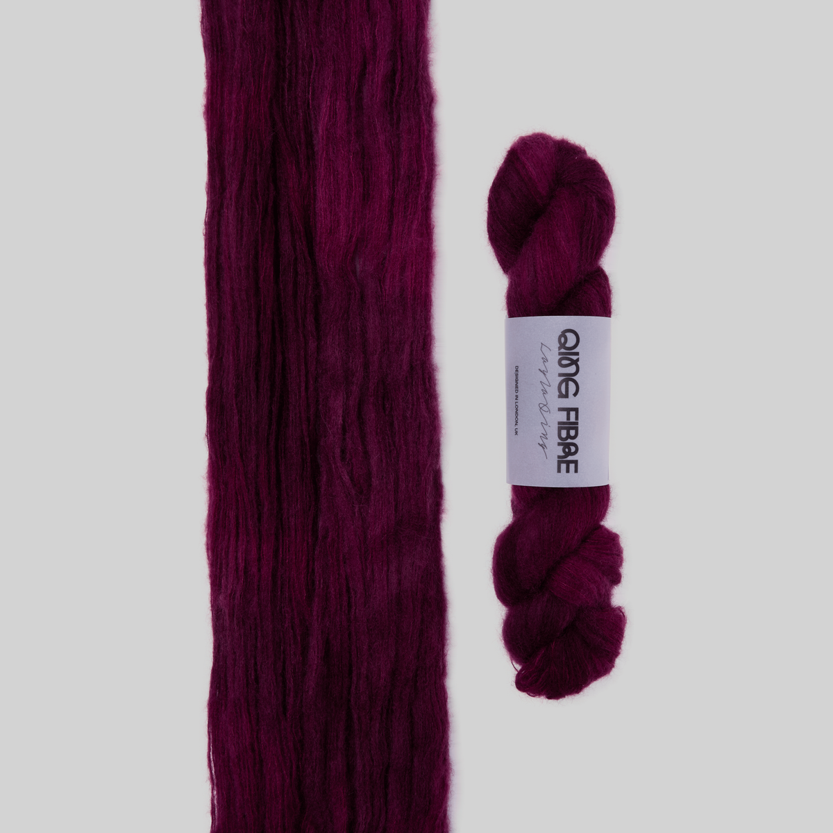 Veranita Hush yarn, with an open skein and twisted skein on a grey background