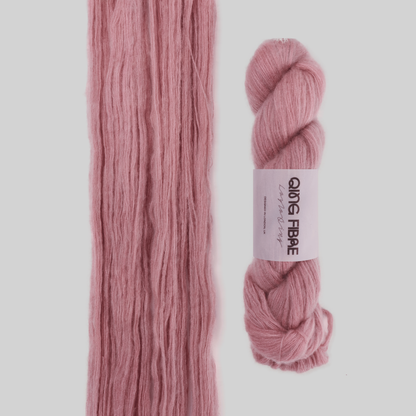Veranita Soft Clay yarn, with an open skein and twisted skein on a grey background